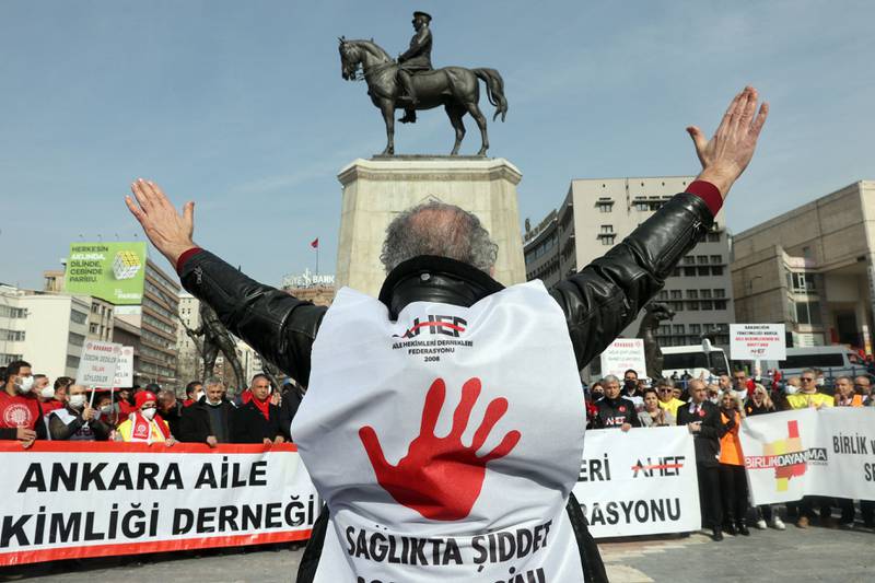 A doctors wear a vest reading "End violence in health" as medics protest in Ulus Square, Ankara, in February 2022. AFP