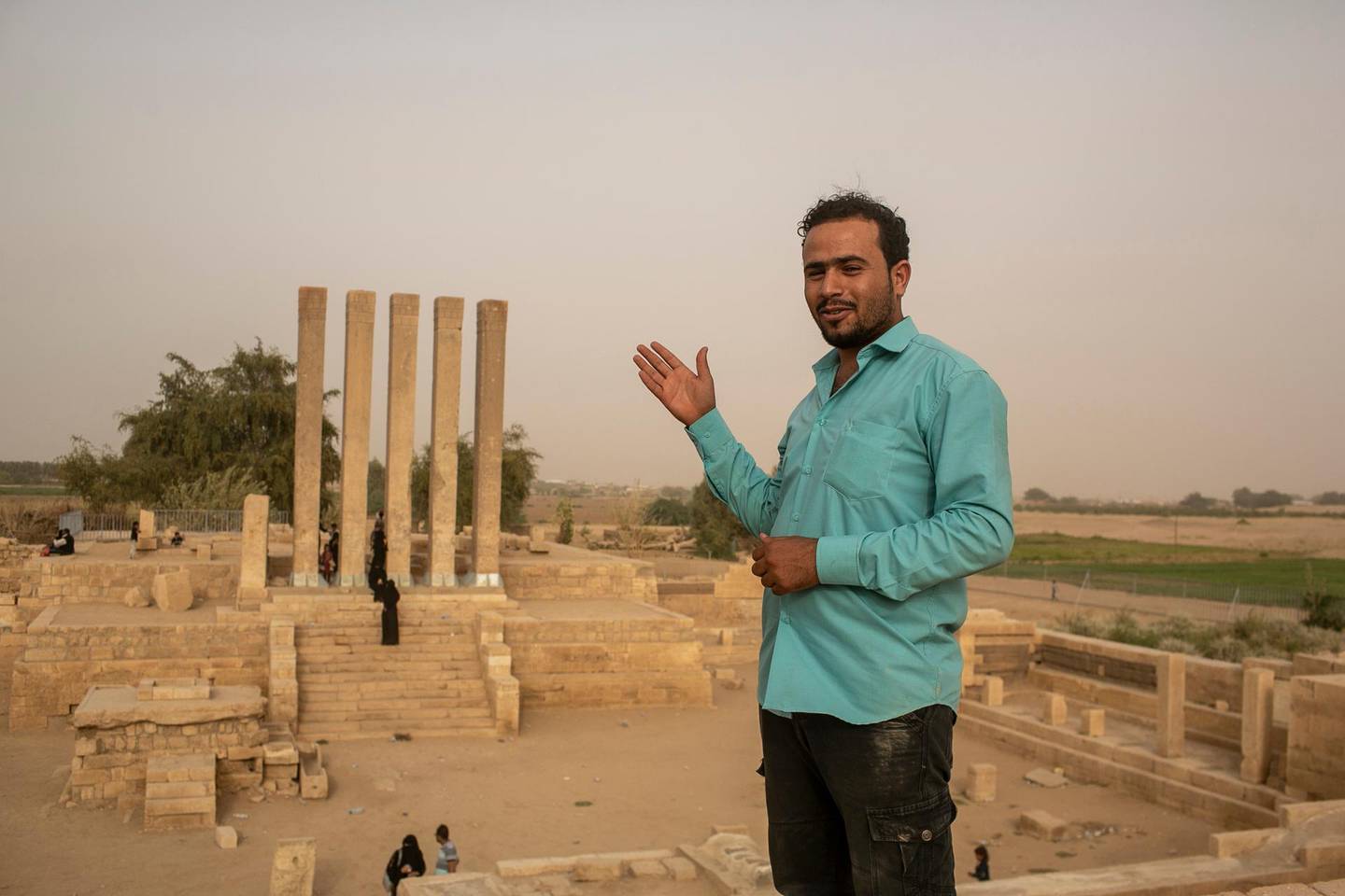 Rashad, 23, in blue shirt, takes a break as he drove visitors to the site of the Queen of Sheba's throne, a temple in Marib, April 4, 2021. Photo/Asmaa Waguih