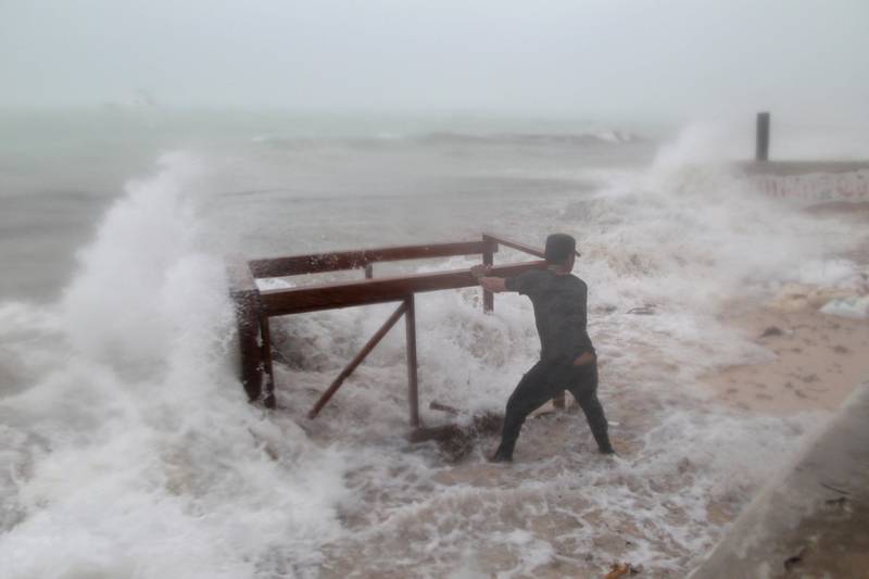A man tries to salvage a table belonging to his restaurant before the arrival of Hurricane Maria in Punta Cana, Dominican Republic. Ricardo Rojas / Reuters
