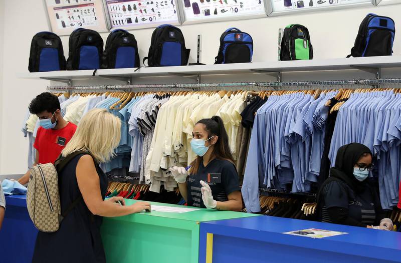 DUBAI, UNITED ARAB EMIRATES , August 13 – 2020 :-  Parents buying school uniform for their kids at the Threads shop at the Times Square in Dubai. Parents need to pre book their visit at the store. (Pawan Singh / The National) For News/Online/Instagram. Story by Kelly