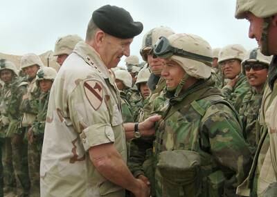 Gen Tommy Franks shakes hands with US Marines of the 1st Marine Expeditionary Force in the Iraqi city of Numaniyah, about 140 kilometres south-east of Baghdad, on April 7, 2003. Getty Images