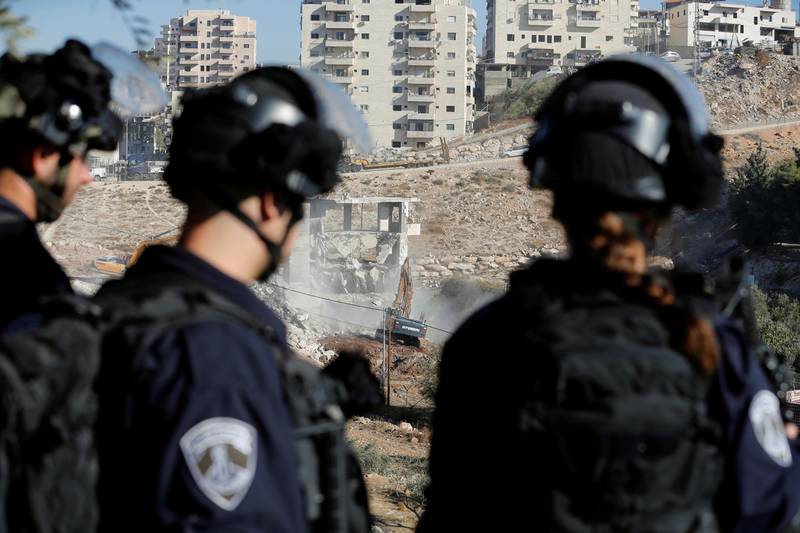 Israeli border police keep guard as bulldozers demolish a Palestinian building in the neighbourhood of Sur Baher, in East Jerusalem. Reuters