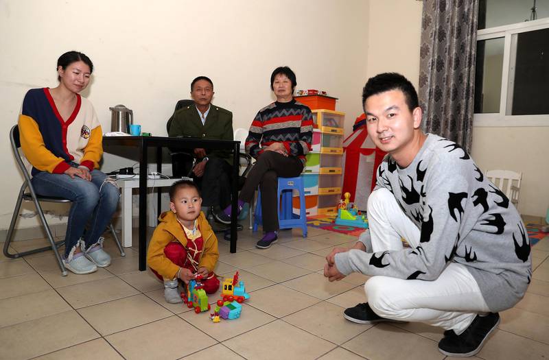 DUBAI, UNITED ARAB EMIRATES , Jan 23  – 2020 :- Cheng Shengping (right) with his family Menglan Zhu (wife left), Changgeng Cheng (Father), Rongya Ma (Mother) and Qianqian (Son) at his flat in International City in Dubai. They are from Wuhan city in China. ( Pawan  Singh / The National ) For News. Story by Ramola