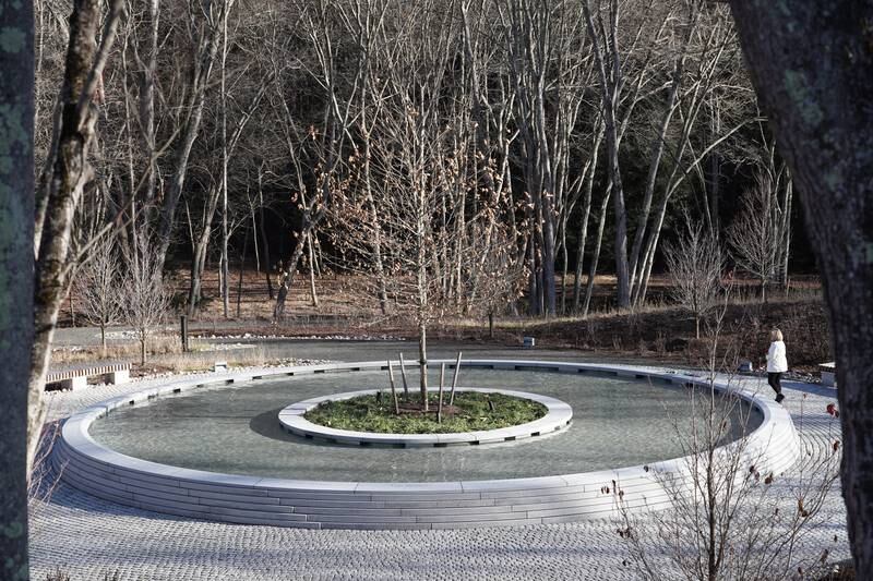 The granite basin surrounding the main water feature is marked with the 26 names of the victims. The National