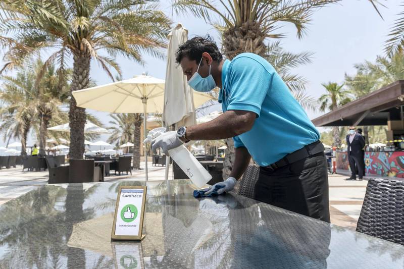 RAS AL KHAIMAH, UNITED ARAB EMIRATES. 21 MAY 2020. A tour with RAK Tourism Development Authority inspectors to know more about Hilton Ras Al Khaimah  Resort & Spa’s preventive and hygiene measures as they open up after the hotel lockdown. A table at the beach restaurant is sanitized after each guests to prevent the possible spread of COVID-19. (Photo: Antonie Robertson/The National) Journalist: Ruba Haza. Section: National.