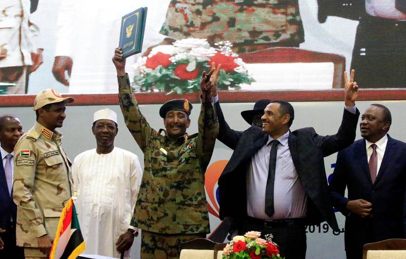 Sudan's Head of Transitional Military Council, Lieutenant General Abdel Fattah Al-Burhan, and Sudan's opposition alliance coalition's leader Ahmad Rabiah, celebrate the signing of the power-sharing deal, that paves the way for a transitional government, and eventual elections. Reuters