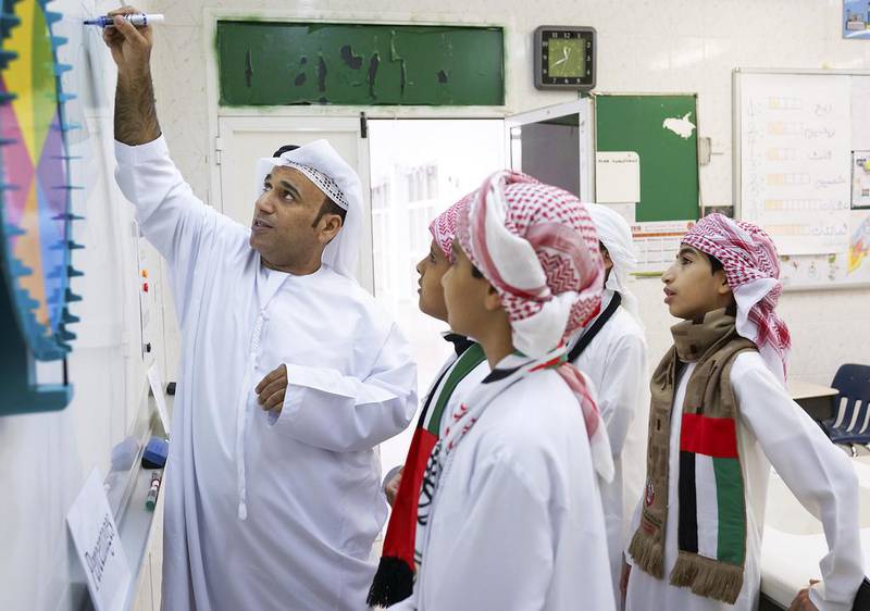 Teacher Khalifa Al Naimi instructs pupils in maths at Al Tamayoz Model School in Al Ain. Delores Johnson / The National