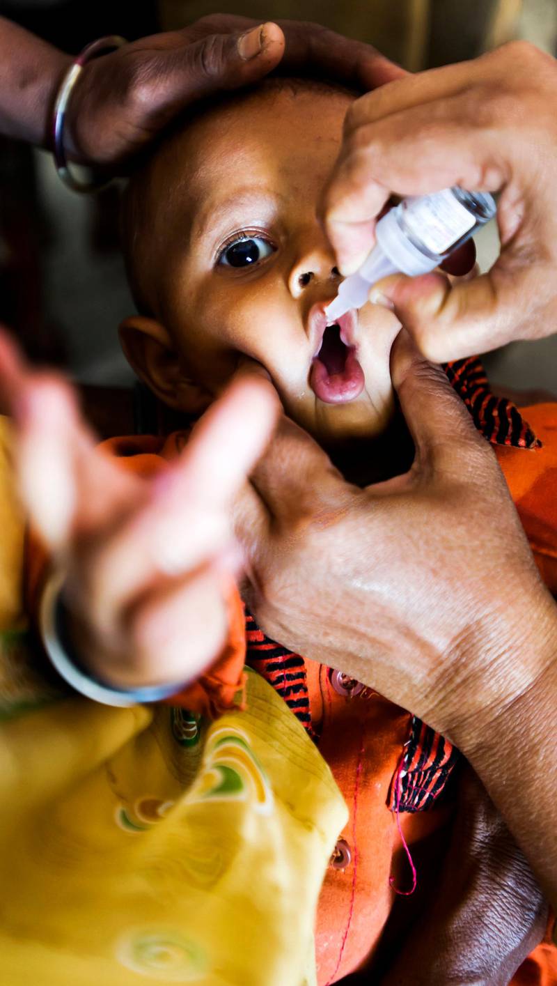 16th February 2011, Umaru Village,  Siddharpur Block, Patan District,  Gujarat, India. Village Health and Nutrition Day (VHND)  / Mamta Diwas in Umaru Village. A child receives Polio vaccine orallyPHOTOGRAPH BY SIMON DE TREY-WHITE