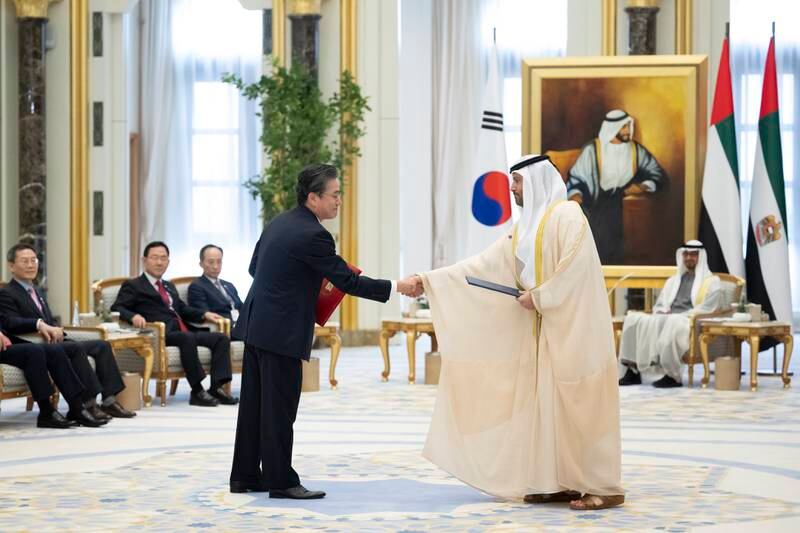 Tareq Al Hosani, board member of Taqa, and a South Korean counterpart exchange an agreement