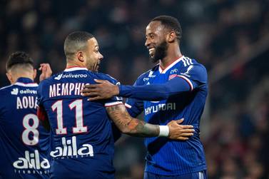 NIMES, FRANCE - December 6: Memphis Depay #11 of Lyon is congratulated by Moussa Dembele #9 of Lyon after scoring from a penalty kick during the Nimes V Lyon, French Ligue 1, regular season match at Stade des Costières on December 6th 2019, Nimes, France (Photo by Tim Clayton/Corbis via Getty Images)