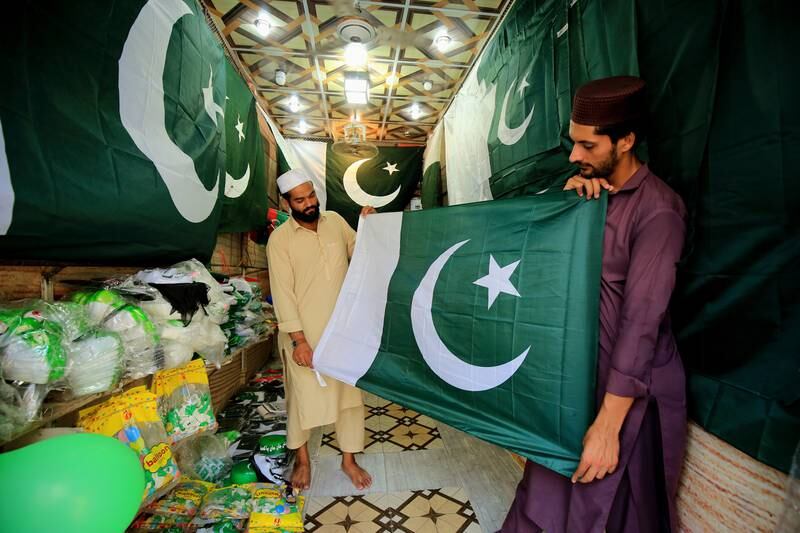 A man buys a national flag at a market in Peshawar, Pakistan, in preparation for Independence Day on August 14. EPA