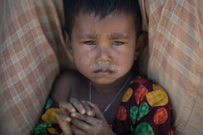 TOPSHOT - A Rohingya Muslim refugee child cries as she sits in the Kutupalong refugee camp in Cox's Bazar on December 4, 2017.
Rohingya are still fleeing into Bangladesh even after an agreement was signed with Myanmar to repatriate hundreds of thousands of the Muslim minority displaced along the border, officials said on November 27.  / AFP PHOTO / Ed JONES
