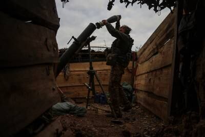 A Ukrainian serviceman loads a shell into a mortar, in Zaporizhzhia region, in September. Reuters