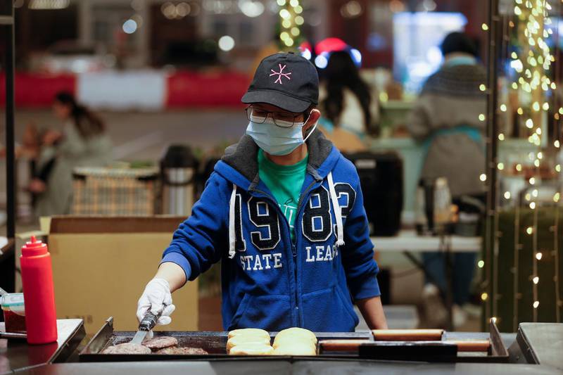 A vendor prepares hamburgers at a food stall at Al Aali Mall amid the coronavirus disease (COVID-19) pandemic, in Manama, Bahrain February 27, 2021. Picture taken February 27, 2021. REUTERS/Hamad I Mohammed