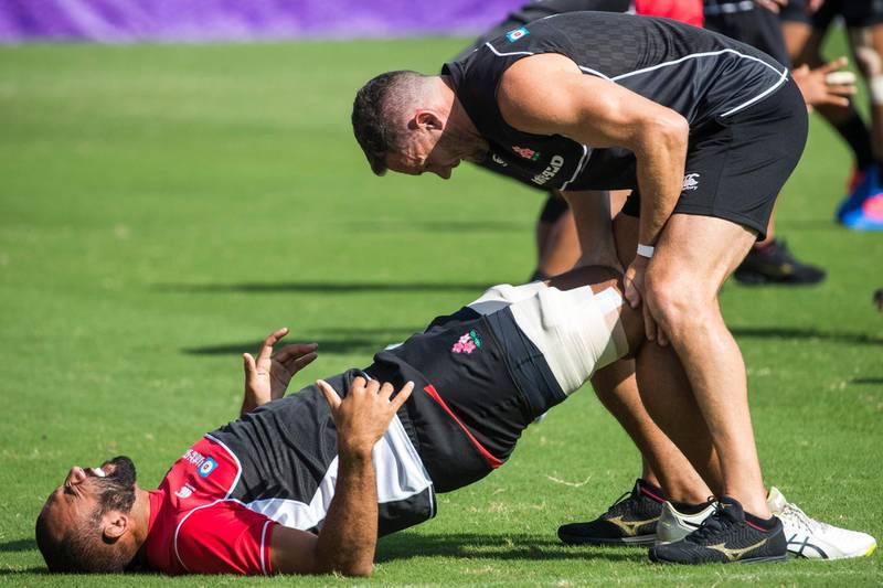 Japan's flanker Michael Leitch receives attention on the pitch during a training session. AFP