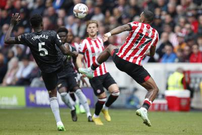 Brentford's Ivan Toney, right, challenges for the ball with Arsenal's Thomas Partey. AP