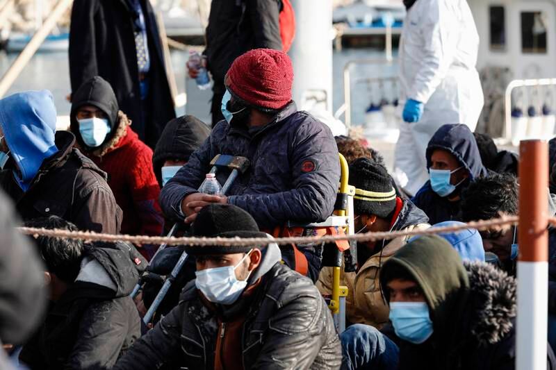 Migrants arrive at the Italian port of Pozzallo, Sicily, after being rescued at sea by a coastguard ship on February 6. EPA