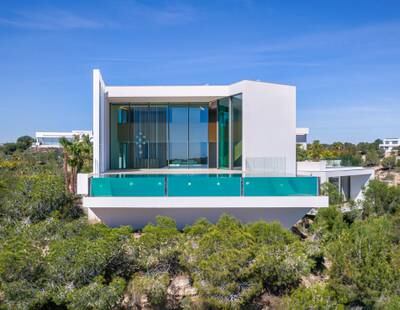 The property is dominated by a seven metre-high facade and two-story aquarium-style glass infinity pool. Photo: Sotheby's International Realty