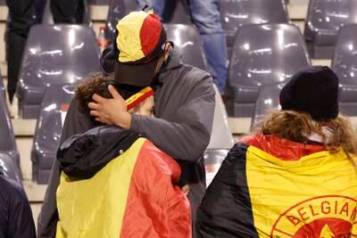 A supporter is comforted on the stands after the match was suspended. AP