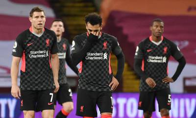Mohamed Salah, centre, and James Milner, left, look dejected after conceding the seventh goal at Villa. Reuters