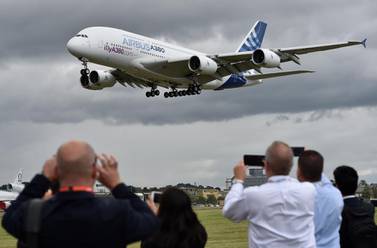 Plane enthusiasts watch an Airbus A380 during a flight demonstration at the Farnborough International Air show in Britain. Airbus will shut down production of the superjumbo due to weaker than expected demand. EPA