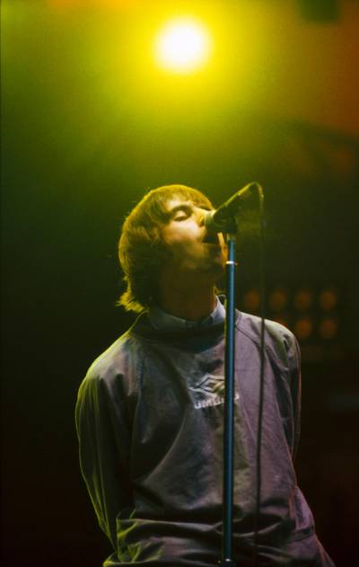 UNITED KINGDOM - APRIL 01:  MAINE ROAD  Photo of OASIS and Liam GALLAGHER, Liam Gallagher performing on stage  (Photo by Patrick Ford/Redferns)
