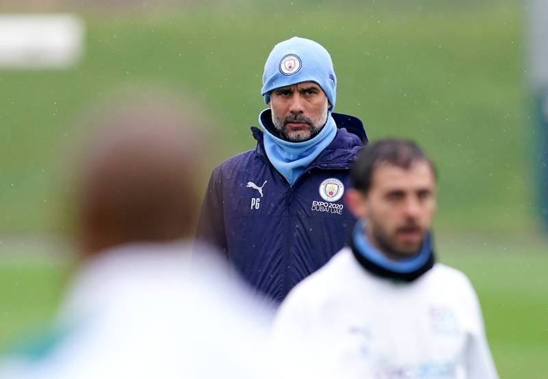 Pep Guardiola oversees a Mancchester City training session at the City Football Academy. PA