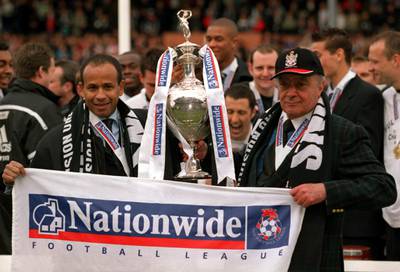 Fulham FC manager Jean Tigana and Mohamed Al Fayed celebrate with the Division One Trophy in 2001.