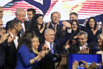 Benjamin Netanyahu waves as members of the Likud party applaud at the party headquarters in Tel Aviv. Bloomberg