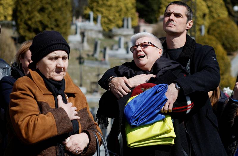 Yurii, brother of Ihor Fedorchyk, 38, a soldier killed by Russian shelling in the town of New Kahovka, hugs his mother, Myroslava, as they mourn during his funeral at the Lychakiv cemetery in Lviv, Ukraine. Reuters