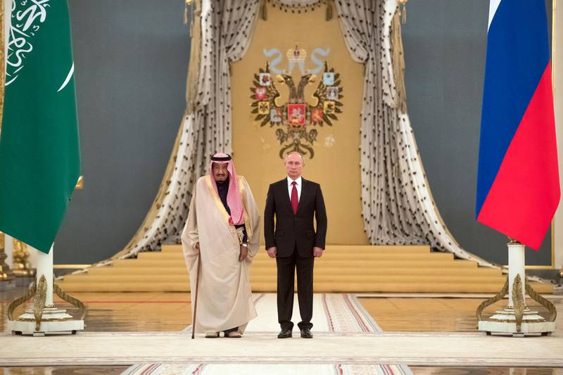 Russian President Vladimir Putin, right, and Saudi King Salman listen national anthems during their meeting in Kremlin, Moscow, Russia, Thursday, Oct. 5, 2017. King Salman arrived in Moscow Wednesday on the first ever visit by a Saudi monarch to Russia. (AP Photo/Pavel Golovkin)