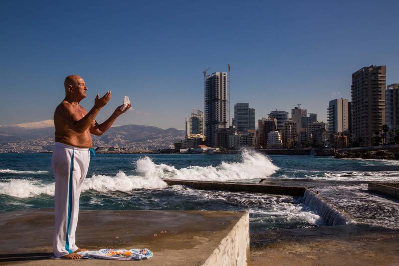 Abu Khodor prays.<br>Beirut, Lebanon - January 10, 2016A.U.B. beach consists of a pool and a concrete area located beside the Corniche, a famous seaside promenade in downtown Beirut. The beach is owned and managed by the American University and is officially open from May through March where activities and infrastructures are provided. Two hours away from this California look alike, fighting is raging in Ras Baalbeck with the Syrian civil war spilling over the border into Lebanon. On February 27th, at the time this photo-essay was shot, the Lebanese Army took part in a vast offensive against Syrian jihadists which resulted in 5 Lebanese soldiers wounded and dozens of Syrian militants killed.In the winter months, the beach is occupied by local residents who come here daily to enjoy a swim and sun tan.Abu Khodor, a prominent member of the sun tanners community has been coming to A.U.B. Beach every day for the past twenty-five years and even recalls swimming while the Israeli Army was bombing the city in 2006. He is held in high regard by the A.U.B. Beach community.Most of those beach goers are devout Muslims and it is not rare to see them praying wearing exclusively a swimsuit; a behavior that seems far away from the Islamic States brutal interpretation of Islam.Photo by Vianney Le Caer. NOTE: For Nick Leech's story
