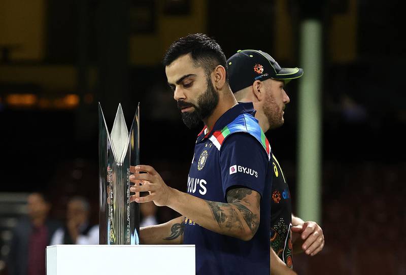 Virat Kohli of India picks up the series trophy after Australia won the third and final match in Sydney by 12 runs on Tuesday. India clinched the series 2-1. Getty