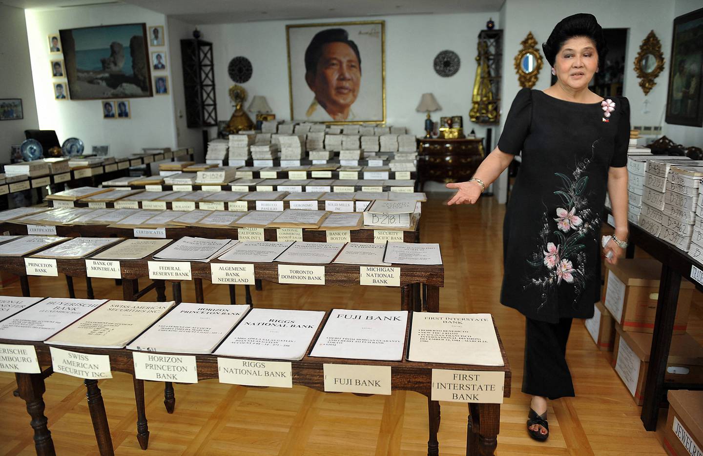 Former First Lady of the Philippines Imelda Marcos walks past her voluminous pending court cases during an interview with AFP at her residence in Manila in 2009. AFP
