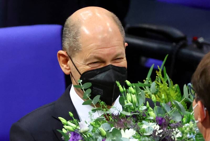Olaf Scholz receives flowers after being elected Germany's new chancellor. Reuters