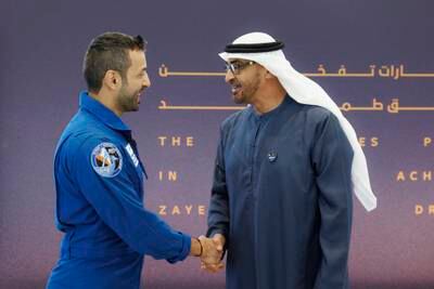 President Sheikh Mohamed shakes hands with Dr Al Neyadi after he arrived in the UAE. Photo: UAE Presidential Court