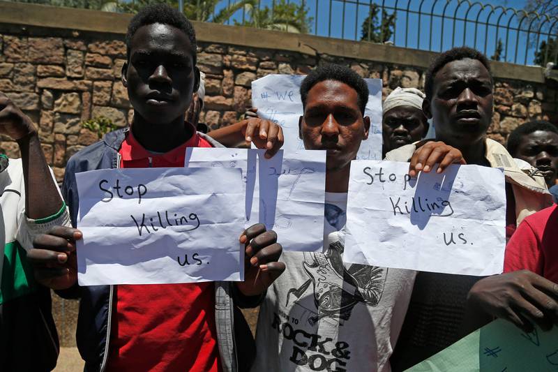 Migrants hold placards during an anti-racism demonstration in the Moroccan capital Rabat on Tuesday. AFP