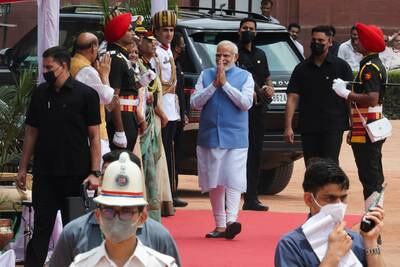 Mr Modi greets officials after arriving at the venue of the swearing-in ceremony. Reuters