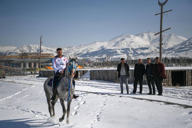 Spectators watch as a competitor warms up before a jereed game in Erzurum, Turkey. AFP