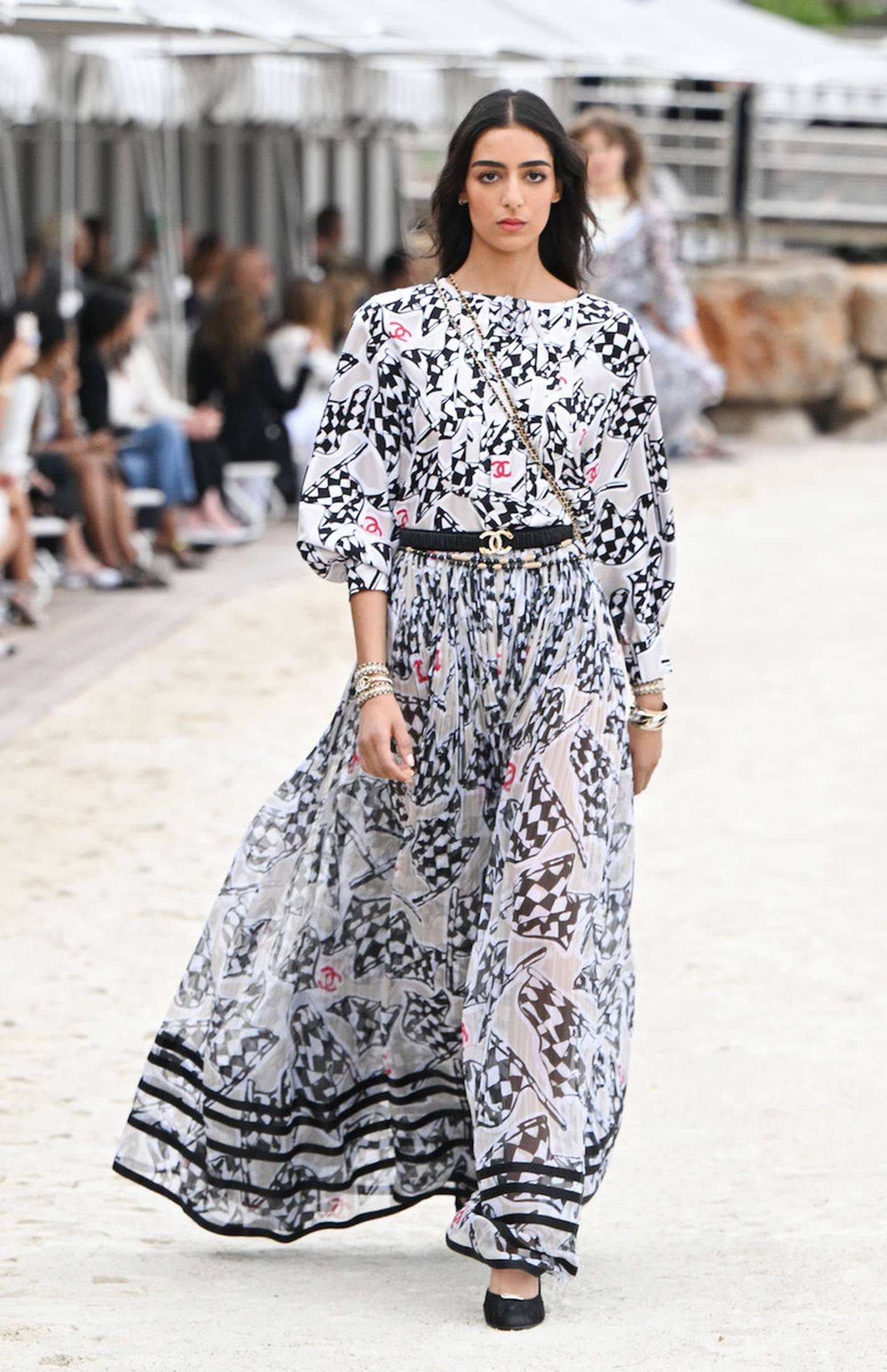 British-Moroccan model Nora Attal wore a flowing dress patterned with checkered flags, for Chanel Cruise. Photo: Chanel