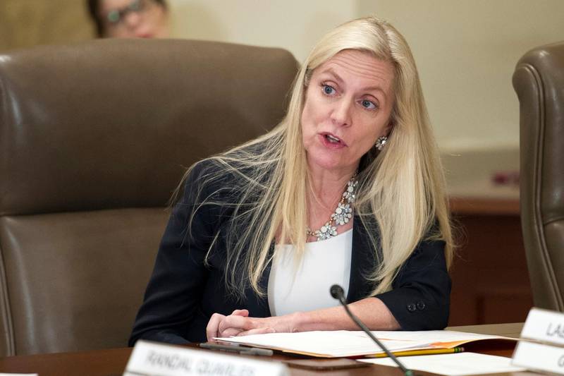 FILE- In this June 14, 2018, file photo Federal Reserve Board Governor Lael Brainard participates in an open meeting in Washington.  Brainard warned Tuesday, July 14, 2020,  that the U.S. economy appears to be slowing after an initial burst of recovery and called for the Fed to take aggressive steps to spur growth.  (AP Photo/Cliff Owen, File)