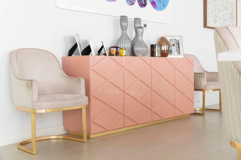A quilted coral pink sideboard is placed next to the dining table. Antonie Robertson / The National
