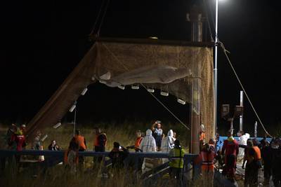 The whale was lifted from the river by a net and crane on Wednesday morning and placed on a barge. AFP