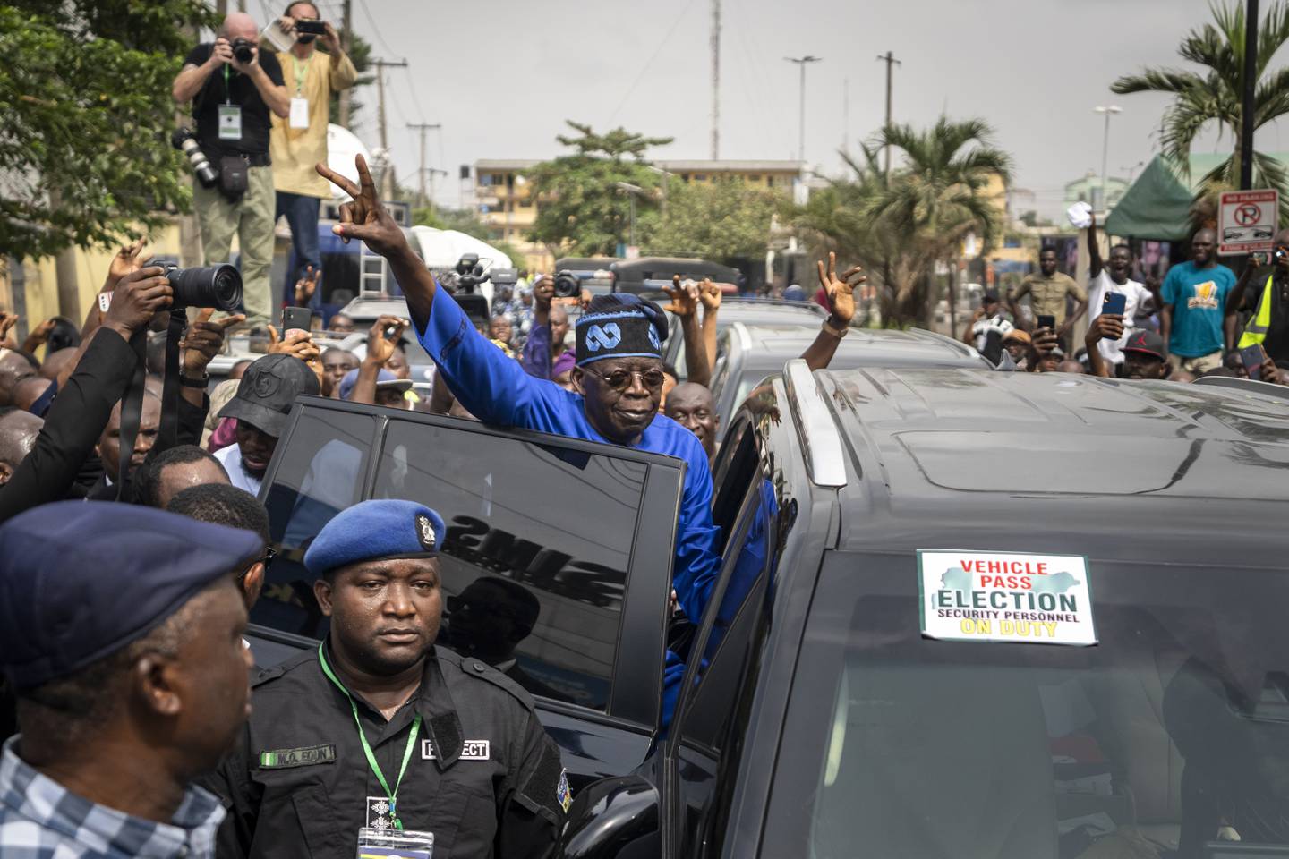 Bola Tinubu of the All Progressives Congress gestures to supporters after casting his vote in the presidential elections in Lagos on February 25. AP