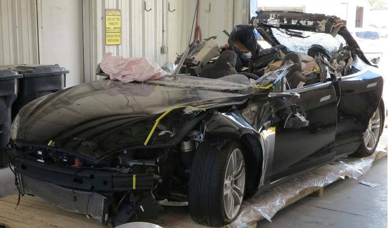 This image provided by the National Transportation Safety Board shows the damage to the left front of the Tesla involved in a May 7, 2016, crash in Williston, Fla. Investigators are meeting Sept. 12, 2017, to determine the likely cause of the crash that killed Joshua Brown, 40, of Canton, Ohio, who was using the semiautonomous driving systems of his Tesla Model S sedan. The sedan struck the underside of a semitrailer that was turning onto a divided highway in Williston. The sedan's roof was sheared off before the vehicle emerged on the other side of the trailer.(NTSB via AP)