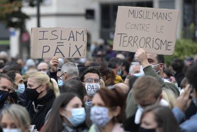 People hold placards reading 'Islam = peace' and 'Muslims against terrorism' as they gather in Strasbourg.  AFP
