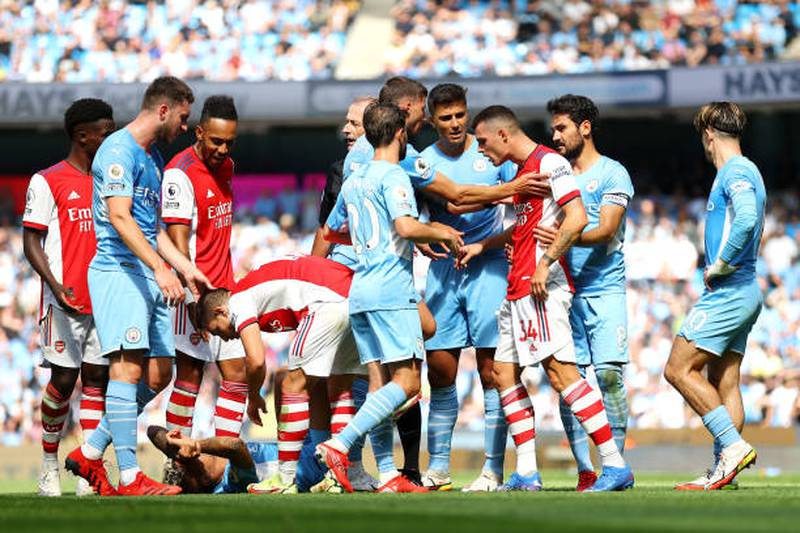 Arsenal's Granit Xhaka is confronted by City players after his challenge on Joao Cancelo that earned him a red card. Getty