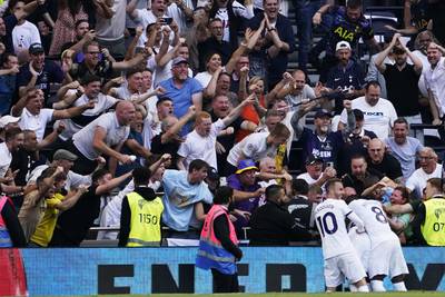 Tottenham's players and fans celebrate after Pape Matar Sarr scored the opening goal. AP