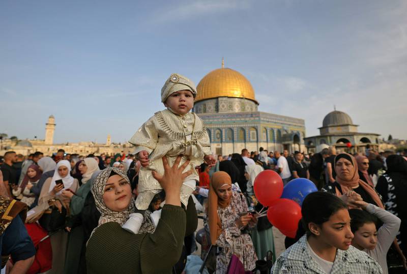 Muslims celebrate in front of the Dome of the Rock mosque after the morning Eid al-Fitr prayer, which marks the end of the holy fasting month of Ramadan, at the Al-Aqsa mosques compound in Old Jerusalem. AFP
