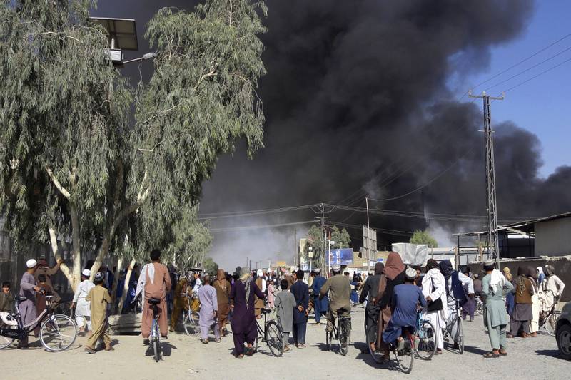 Smoke plumes as the Taliban and Afghan government forces fight for control of key southern city Kandahar.